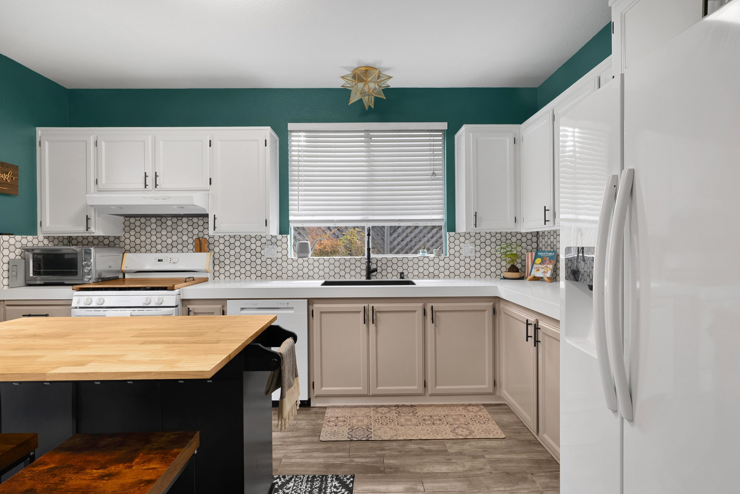 Kitchen with butcher block island and hex tile backsplash