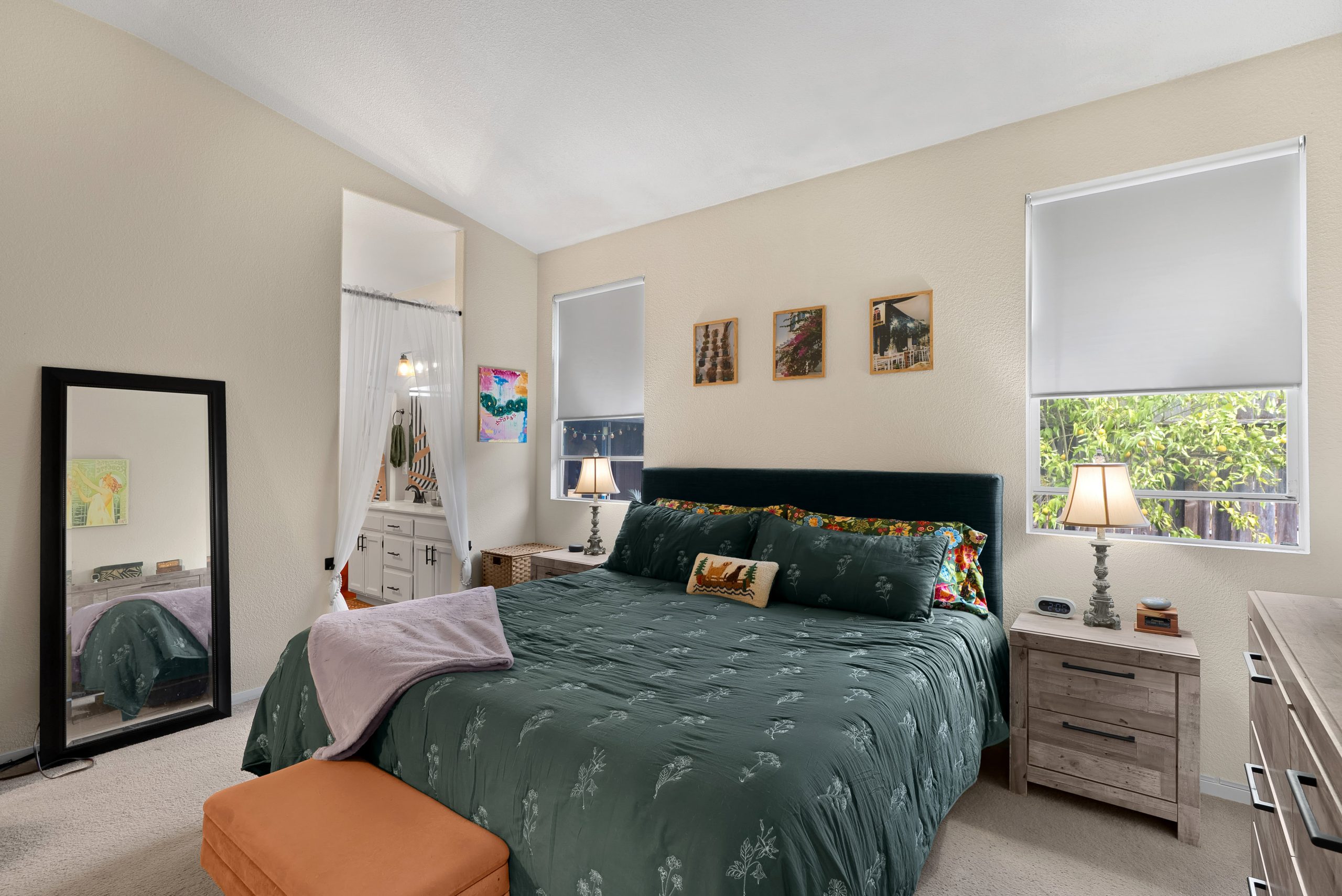 Primary bedroom with vaulted ceiling